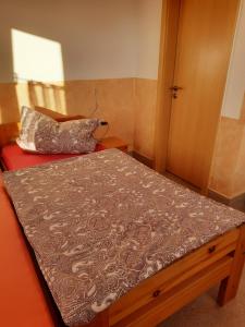 a small bedroom with a bed with a pillow on it at Haus Panoramablick Familie Loos in Wasungen