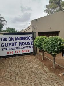 a sign for a guest house in front of a building at 180 On Anderson Guest House in Pretoria