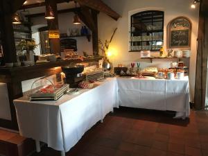 a restaurant with a table with a white table cloth at Landhotel Belitz Garni in Küsten