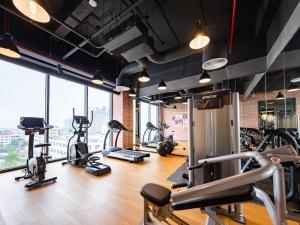 a gym with treadmills and elliptical machines at Tru by Hilton Nam Dinh City Centre in Nam Ðịnh