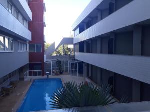 a swimming pool in the middle of a building at Atalaia Apart Hotel in Aracaju