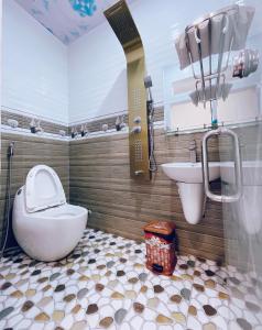 a bathroom with a toilet and a sink at Hotel Diễm My in Quy Nhon