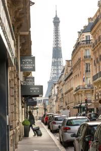 uma pessoa a andar numa rua com a Torre Eiffel em Elysées Union em Paris
