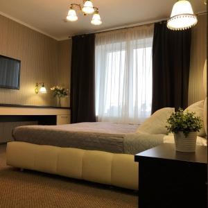 Кровать или кровати в номере Гостиница Атмосфера