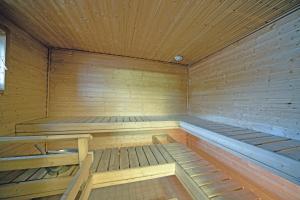 an empty wooden sauna with wooden floors and ceilings at Apartments Tahko in Tahkovuori