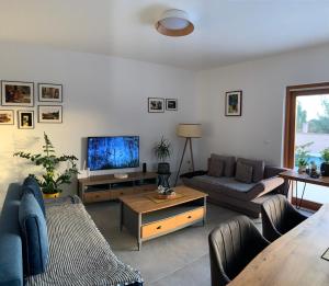 a living room with a couch and a tv at Pine Tree Villa in Pakoštane