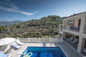 a villa with a swimming pool and a balcony at Gallis Villa in Pefkias