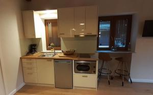 a kitchen with a sink and a stove top oven at Andros 4 All Seasons Villas & Suites in Andros