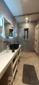 a bathroom with a sink and a mirror at Andros 4 All Seasons Villas & Suites in Andros