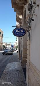 a sign on the side of a building on a street at Casa Cristina in Siracusa