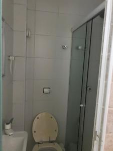 a bathroom with a toilet and a glass shower at Ap frente ao mar in Sao Paulo +5 photos