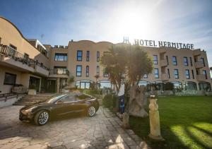 a car parked in front of a building at Hotel Hermitage in Galatina