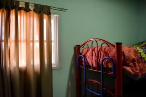 a bedroom with a bunk bed with a window at Cabañas de la bodega Romano-Pin in Albardón
