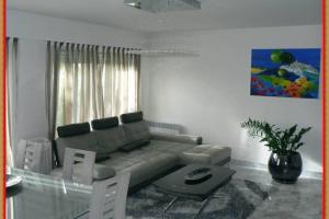 a living room with a couch and a table at Penthouses+Terrasse 60 m2+Box 2 Vehicules in Beausoleil
