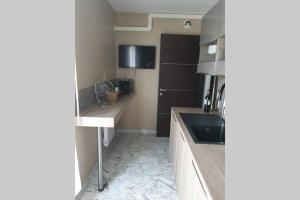 a kitchen with a sink and a counter top at Penthouses+Terrasse 60 m2+Box 2 Vehicules in Beausoleil