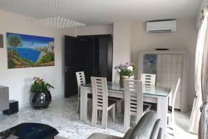 a dining room with a table and chairs at Penthouses+Terrasse 60 m2+Box 2 Vehicules in Beausoleil +19 photos