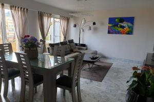 a living room with a table and a couch at Penthouses+Terrasse 60 m2+Box 2 Vehicules in Beausoleil