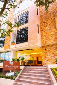
a brick building with a clock on the side of it at EcoHub Hotel Medellin in Medellín

