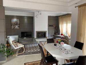 a living room with a table and a fireplace at Seascape Village in Kalithies