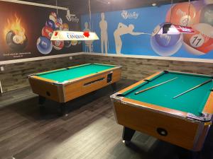 two pool tables in a room with a mural at Valley Motor Lodge in Minnedosa