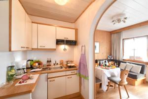 a small kitchen with a sink and a table at Appartements Villa Fortuna in Tirolo