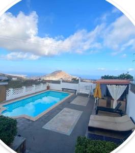 a swimming pool with a view of a mountain at La Casita De Juani in Santa Maria de Guia de Gran Canaria
