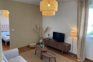 sala de estar con sofá, TV y mesa en Villa SAGRADA - LE BOHEME ****, en Toulouse