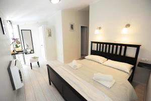 a bedroom with a large bed with two towels on it at City Class Accommodation in Zadar