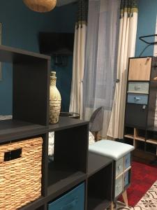 a living room with a black entertainment center with a tv at Chambre D'hôte Villa Maurice in Étretat