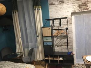 a bedroom with a bed and a dresser and a window at Chambre D'hôte Villa Maurice in Étretat
