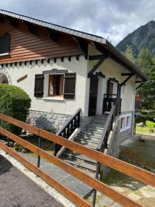 a house with a fence in front of it at Chalet "Le Mayouret" - STUDIO N°4 - chemin des écureuils in Cauterets +12 photos
