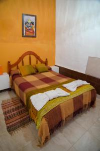 a bedroom with a large bed with towels on it at Cabañas del Sol in Tafí del Valle