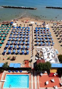 an overhead view of a beach with umbrellas and a swimming pool at Hotel Promenade in Montesilvano