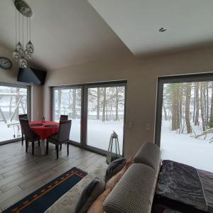 a living room with a couch and a table at Agro Breza domek nad samym jeziorem- sauna ogrodowa in Lipusz +46 photos