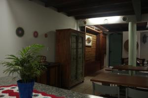 a dining room with a table and a wooden cabinet at Acapela Hospedagem in Ouro Preto