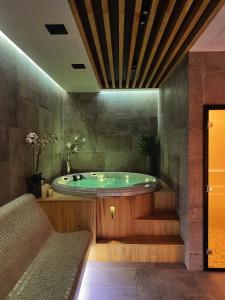 a bathroom with a tub in the middle of the room at Apartmani Banja SPA in Vrnjačka Banja