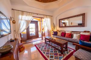 a living room with a couch and a mirror at Charming Lagoon Villa with pool Egyptian Style -Sabina 117 in Hurghada