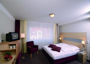 Postel nebo postele na pokoji v ubytování Garten-Hotel Ponick