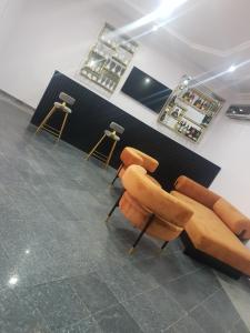 a room with two chairs and a bar at Executive Home Extension in Lagos