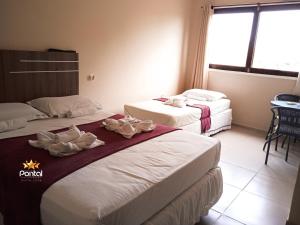 En eller flere senge i et værelse på Pousada Pontal das Estrelas