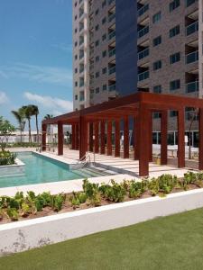 a pavilion in front of a building with a pool at SALINAS EXCLUSIVE RESORT in Salinópolis