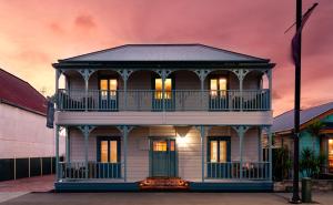 a large white house with a balcony on top at 415 Marine Parade in Napier