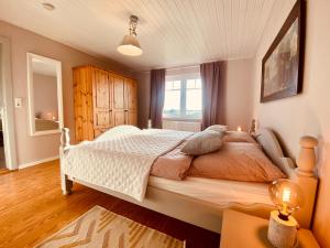 a bedroom with a large bed and a window at Hof Goosend - Urlaub an der Ostsee & Schlei in Gelting