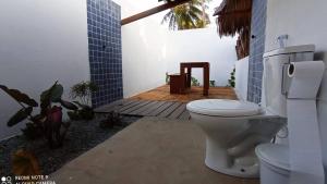 a bathroom with a toilet in a room at Pousada Eureka in Atins