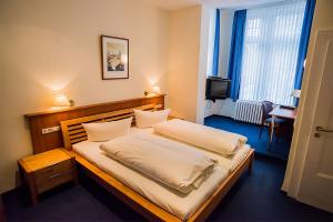Ένα ή περισσότερα κρεβάτια σε δωμάτιο στο Golfhotel Denzerheide