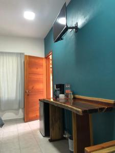 a kitchen with a wooden counter and a blue wall at Hotel "Casa Las Lolas" in Xpujil