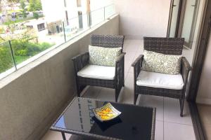 two chairs and a table on a balcony at Departamento ubicado en el corazón de Las Condes. in Santiago