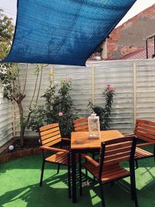 een houten tafel en stoelen op een terras bij VERACI Apartments in Sibiu