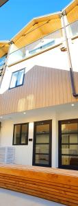 a building with a wooden fence in front of it at The Alex Apartments in Queenstown