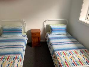 Postel nebo postele na pokoji v ubytování North Avoca - Superior Beach Flat